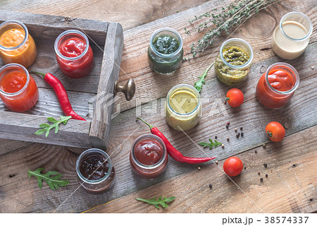 Assortment of sauces in the glass jars 38574337