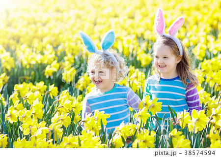 Kids with bunny ears on Easter egg hunt. Kids with bunny ears on Easter egg hunt. 38574594