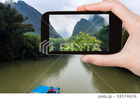 tourist photographs river and karst peaks tourist photographs river and karst peaks 38574656