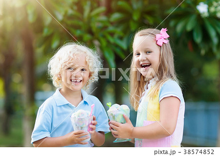 Kids eating ice cream. Child with fruit dessert. Kids eating ice cream. Child with fruit dessert. 38574852