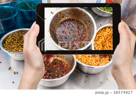 tourist photographs bowl with spicy sauce in China tourist photographs bowl with spicy sauce in China 38574927