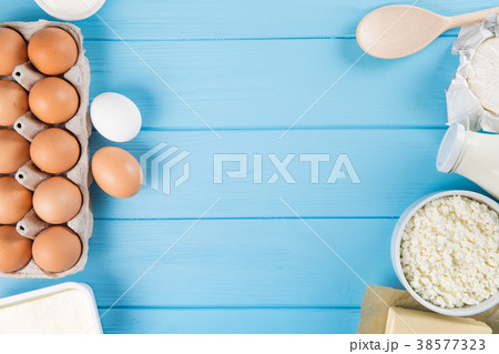 Dairy products on blue wooden table.  38577323