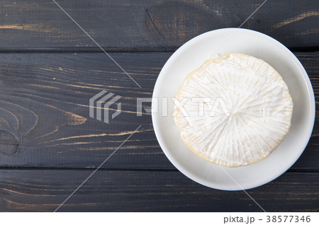 cheese camembert, on a wooden background. 38577346