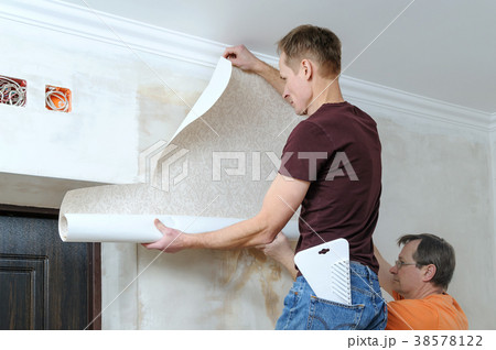 Glueing wallpapers at home. 38578122