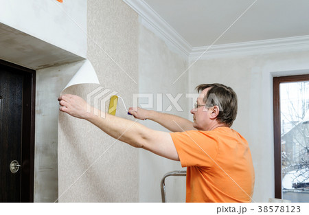 Glueing wallpapers at home. Glueing wallpapers at home. 38578123