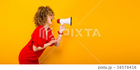 Attractive woman with curly hair with loudspeaker Attractive woman with curly hair with loudspeaker 38578416