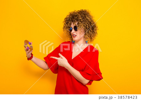 Attractive woman with curly hair with disc Attractive woman with curly hair with disc 38578423