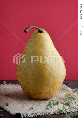 Yellow pear on red background 38579183