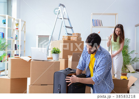 Young family unpacking at new house with boxes 38583218