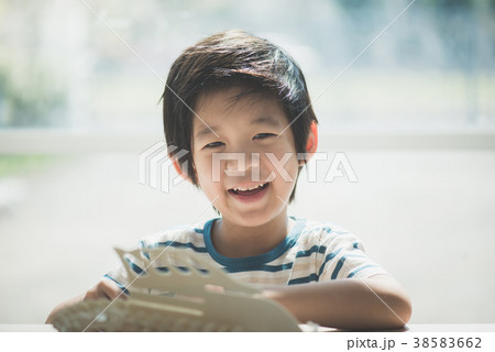Asian child  builds a toy of wood 38583662