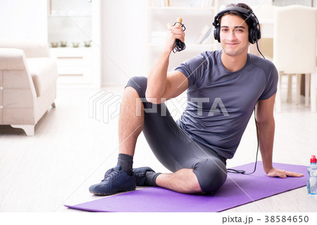 Man doing sports at home and listening to music 38584650