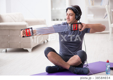 Man doing sports with resistance band and 38584654