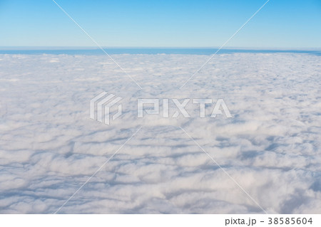 White clouds with blue sky and horizon 38585604