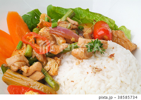 Chicken with rice and vegetables in background Chicken with rice and vegetables in background 38585734