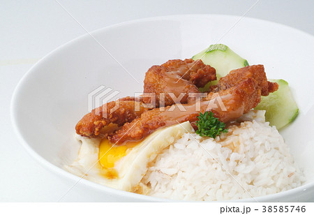 Chicken with rice and vegetables in background Chicken with rice and vegetables in background 38585746