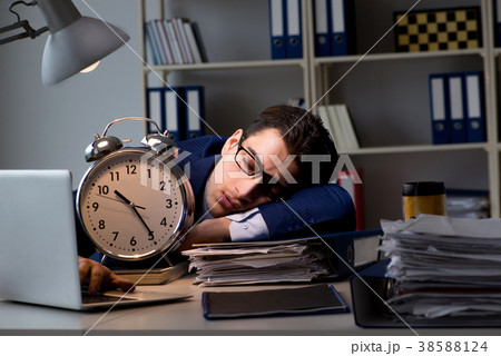 Businessman falling asleep during long hours in 38588124