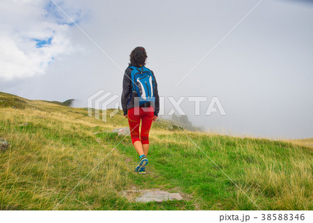 Lonely girl during an excursion in the mountains Lonely girl during an excursion in the mountains 38588346