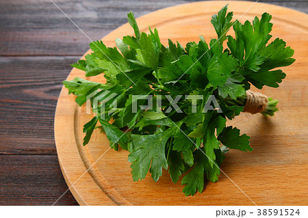 Fresh green parsley on the wooden table Fresh green parsley on the wooden table 38591524
