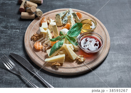 Cheese plate with cheeseson the table from  38593267