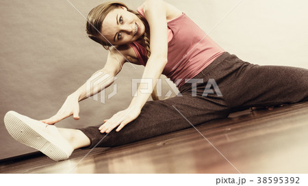 Woman in sportswear stretching legs 38595392