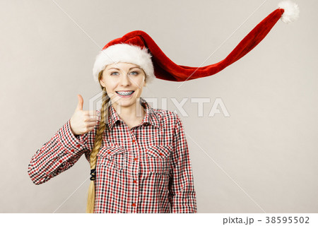 Happy woman wearing Santa Claus helper hat 38595502