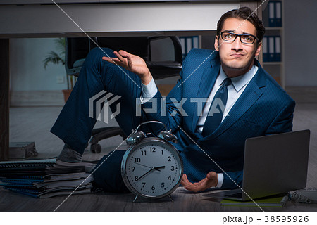 Businessman working overtime long hours late in Businessman working overtime long hours late in 38595926