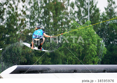 Wake board rider jumping and flying trick 38595976
