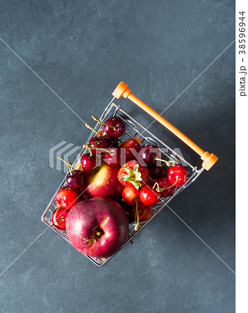 Fresh red fruit berries supermarket cart on black 38596944