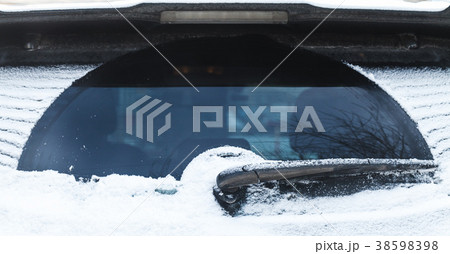 Car wiper on rear window covered with snow Car wiper on rear window covered with snow 38598398