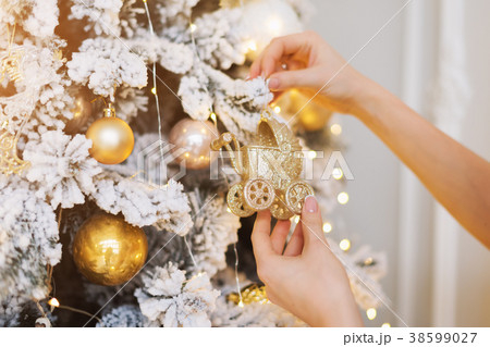 Woman decorating the New Year tree. Christmas tree Woman decorating the New Year tree. Christmas tree 38599027