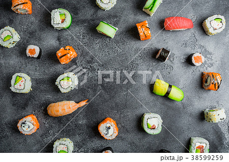 Pattern of sushi rolls on a dark background Pattern of sushi rolls on a dark background 38599259