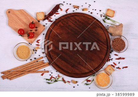 Food frame around brown round cutting board  38599989