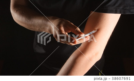 DOPING: Athlete does injection himself in hand DOPING: Athlete does injection himself in hand 38607691