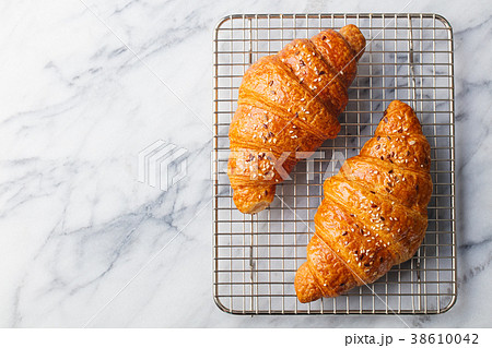 Croissants on cooling rack. Marble background Croissants on cooling rack. Marble background 38610042