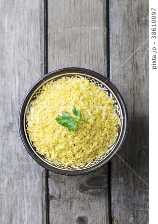 Couscous in bowl. Wooden background. Top view Couscous in bowl. Wooden background. Top view 38610097