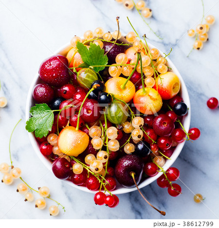 Assortment of fresh berries in white bowl Top view Assortment of fresh berries in white bowl Top view 38612799