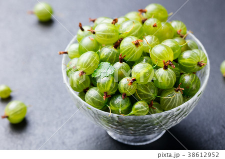 Gooseberries in glass bowl Slate background 38612952