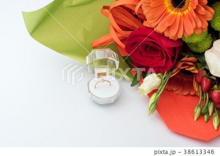 Engagement ring in a gift box with bright bouquet Engagement ring in a gift box with bright bouquet 38613346