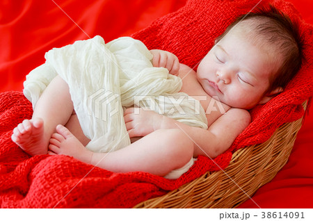 Newborn baby girl is sleeping on fur blanket Newborn baby girl is sleeping on fur blanket 38614091