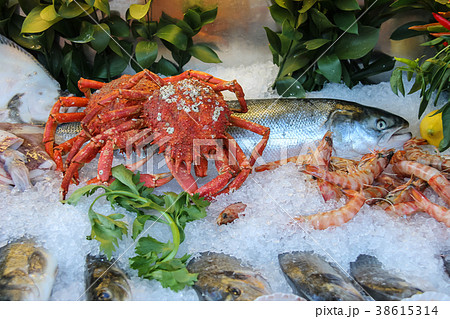 Fresh and cooked seafood in ice on display case Fresh and cooked seafood in ice on display case 38615314