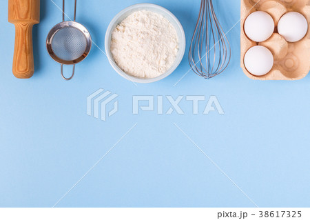 Ingredients for baking  on a blue background. 38617325