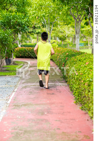 Rare view of young asian boy run in garden. 38621194