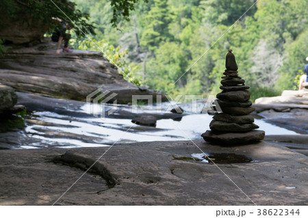 Pile of rocks by a waterfall 38622344