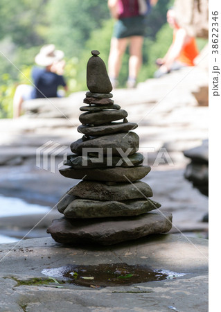 Pile of rocks by a waterfall 38622346
