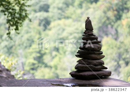 Pile of rocks by a waterfall Pile of rocks by a waterfall 38622347