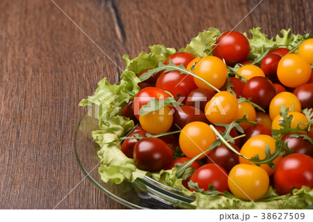 Glass plate with cherry tomatoes rustic style 38627509