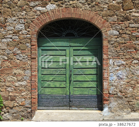 Green wooden gate in an old stone Italian house Green wooden gate in an old stone Italian house 38627672