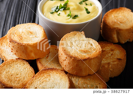 crostini and cheese creamy sauce dip close-up 38627917
