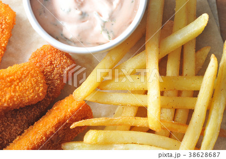 fried fish sticks with sauce with French fries fried fish sticks with sauce with French fries 38628687