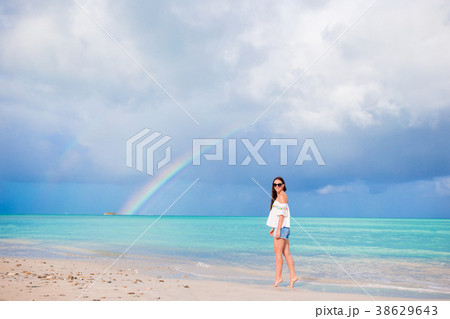 Beautiful happy woman on the beach with beautiful 38629643